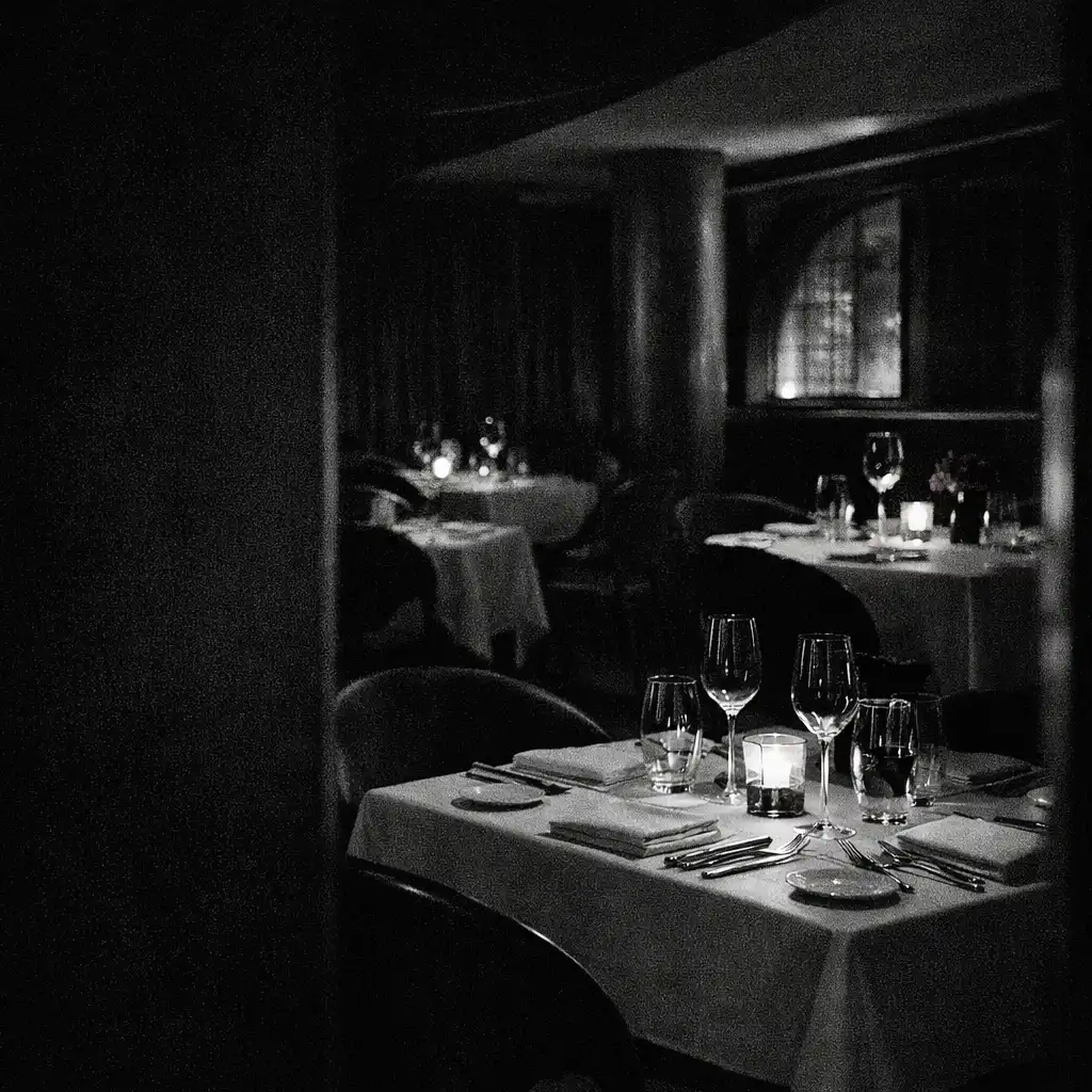 Prepared dining table in a shadowed nocturnal restaurant room