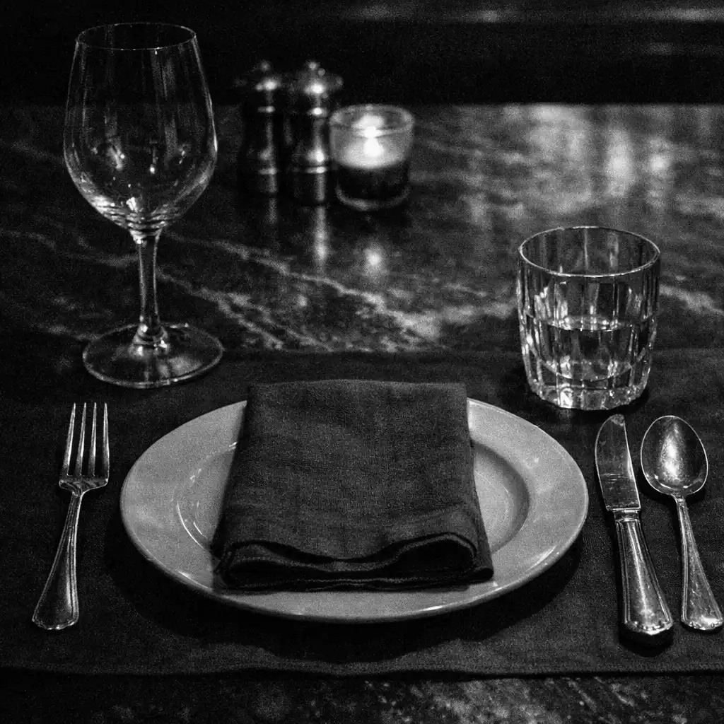 Dark linen and a precise dining table place setting